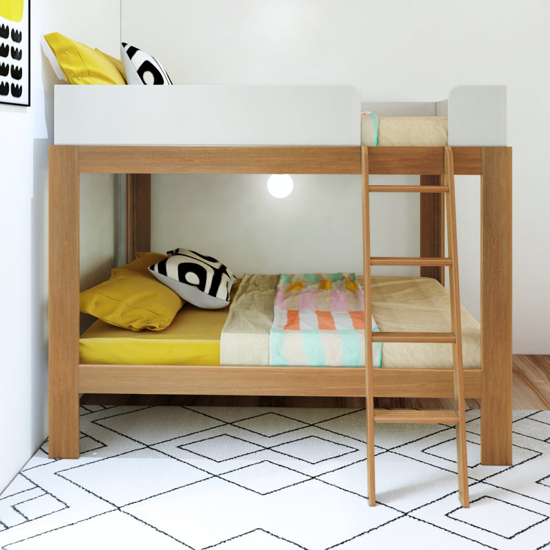 Modern wooden bunk bed with colorful bedding and cushioned pillows in a bright room.