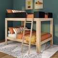 Modern wooden loft bunk bed with ladder, orange linens and striped pillows against a dark green wall with framed trophy and sneaker prints