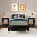 Modern children's bedroom decor: green bed with plush rhino and striped pillow, nightstands with lamps, framed animal wall art