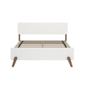 Mid-century modern white platform bed frame with rounded headboard panel, wooden tapered legs and slatted wood base with support straps
