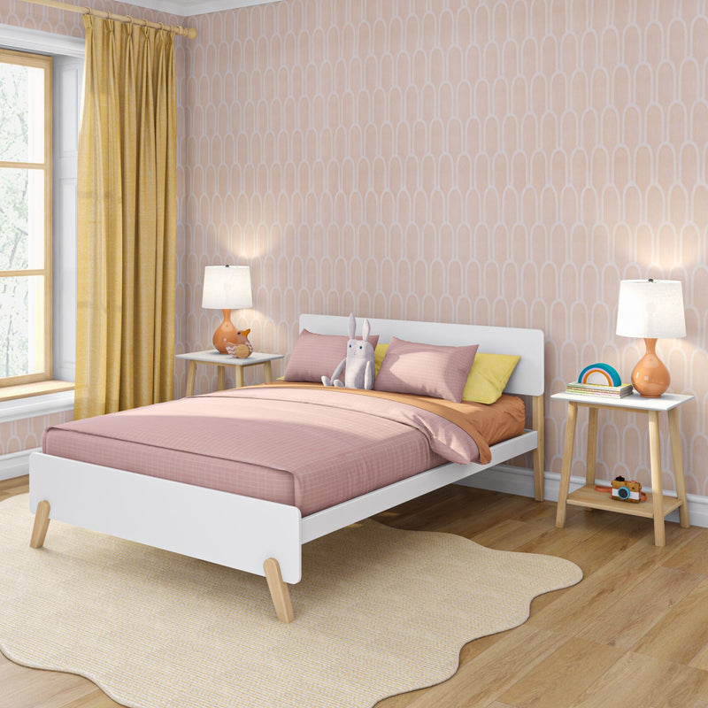 Modern Scandinavian children's bedroom with white platform bed, pink bedding, pastel arched wallpaper, yellow curtains, wooden nightstands and stuffed rabbit