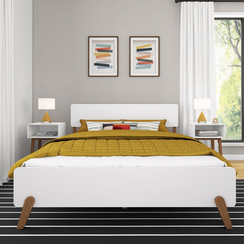 Modern bedroom with white bed frame, mustard yellow bedding, and contemporary decor.