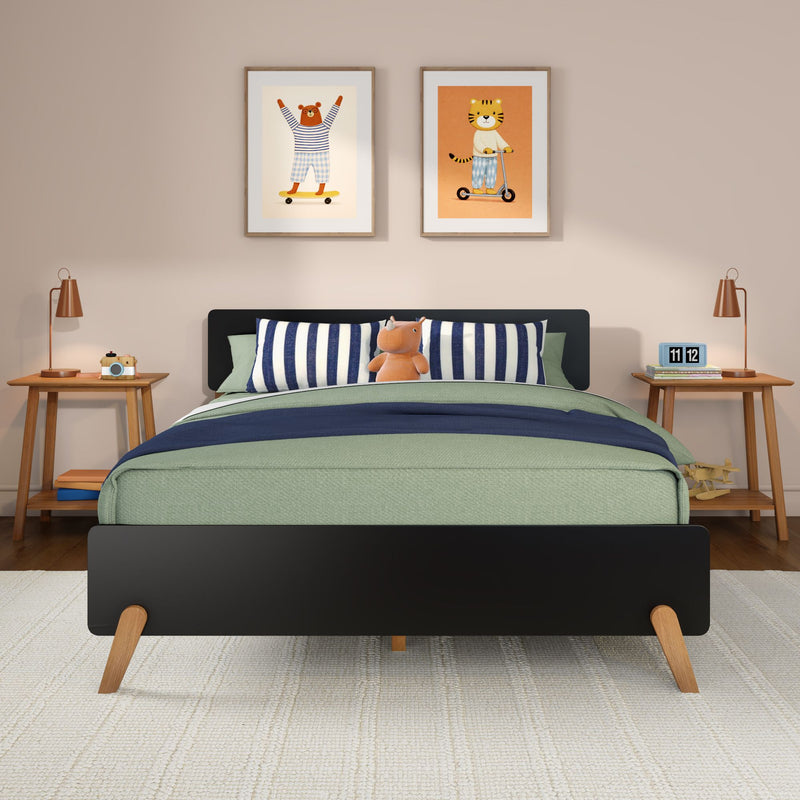 Modern kids bedroom nursery with green bedding, navy-striped pillows, plush hippo, wooden nightstands, copper lamps and framed tiger and bear wall art