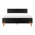 Modern black platform bed with rounded headboard and footboard, oak tapered legs and white mattress — minimalist mid-century bedroom furniture