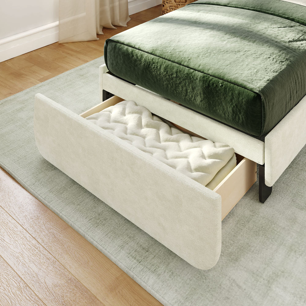 Modern bed with built-in storage drawer under green velvet bedding in a stylish bedroom setting.