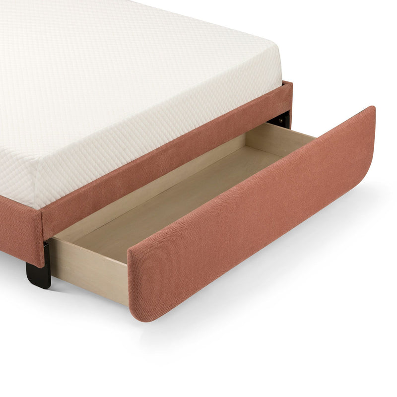Rust-colored upholstered bed with white mattress and open storage drawer.