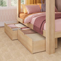 Wooden canopy children's bed with pink and peach bedding, plush bunny and open under-bed storage drawers for organized kids bedroom