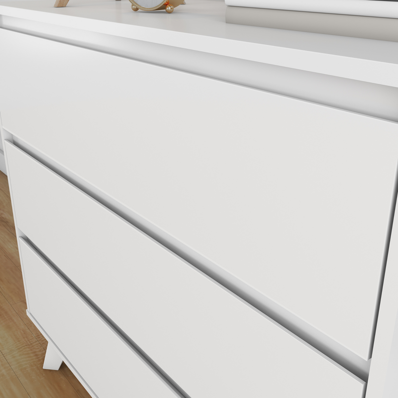 White modern dresser with sleek drawers on a wooden floor background.