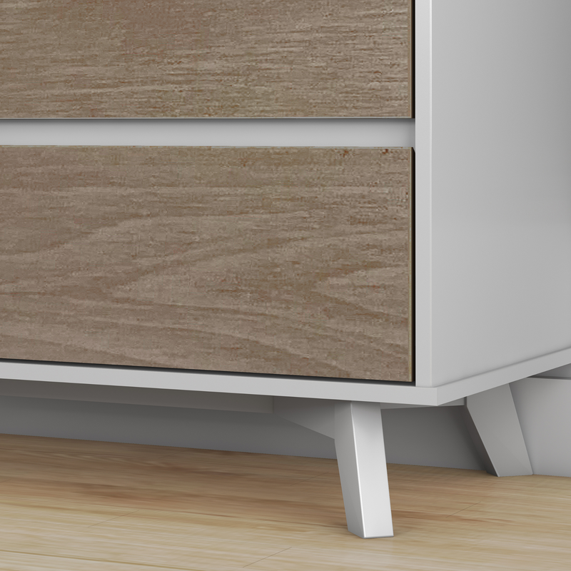 Close-up of mid-century modern dresser with wood veneer drawer fronts, white frame and angled tapered legs on hardwood floor