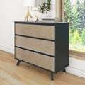 Mid-century modern three-drawer dresser with matte black frame and natural wood drawer fronts on angled legs, bedroom storage console styled with lamp, clock and potted plant