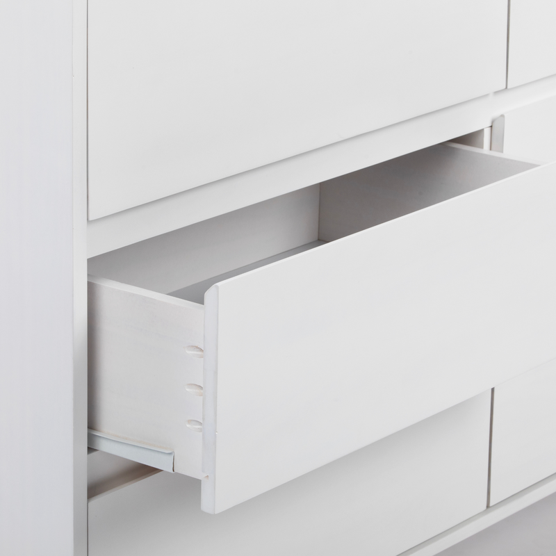 Close-up of a minimalist white wooden dresser with an open empty drawer and visible metal slide, modern bedroom storage