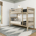 Natural light wood twin-over-twin bunk bed in a modern minimalist kids' bedroom with white walls, ladder and guardrails, black-and-white striped bedding, decorative pillows, wall sconces, woven window shade and patterned area rug