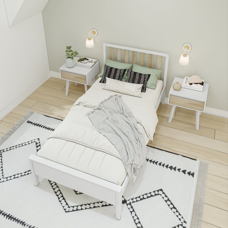 Modern minimalist Scandinavian bedroom with white wooden bed and slatted headboard, green pillows, matching nightstands, wall sconces, and black-and-white geometric rug
