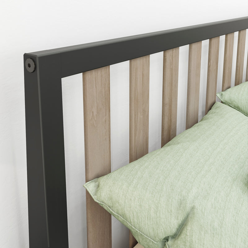 Modern headboard with matte black metal frame and vertical oak slats beside light green pillow — minimalist bedroom decor