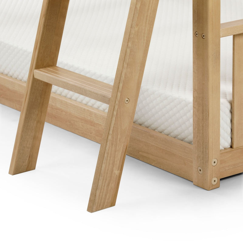 Close-up of light natural wood bunk bed ladder and frame with white textured mattress, showing solid wood steps, corner joints, and metal fasteners