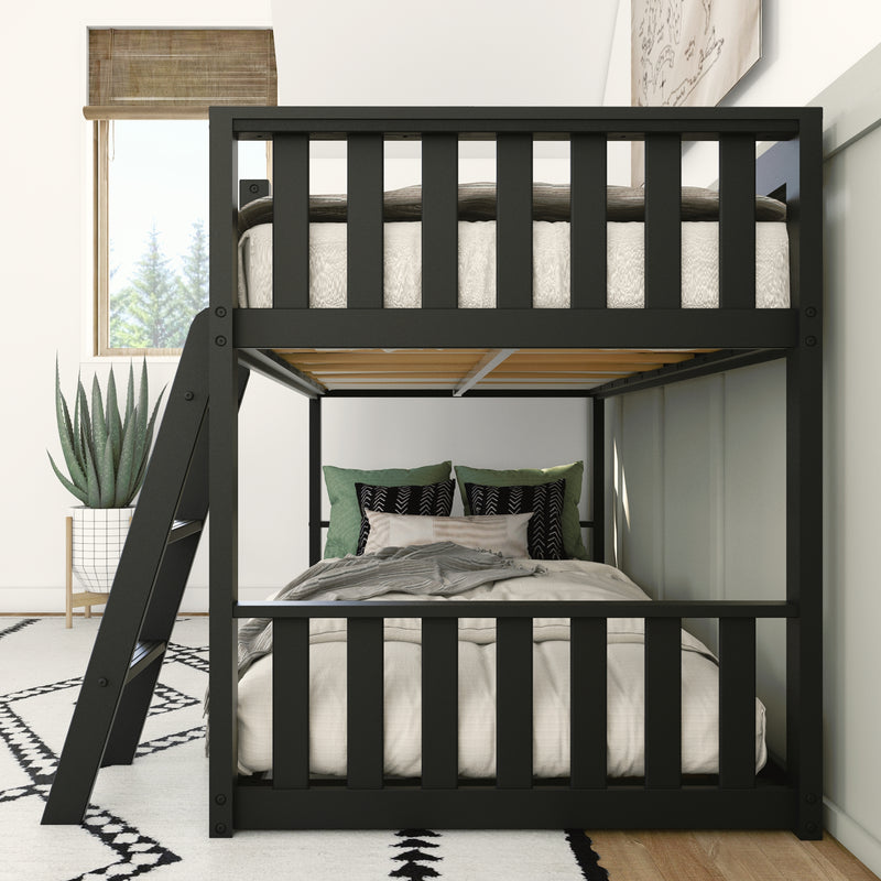 Modern black bunk bed with cozy bedding in stylish bedroom decor featuring green and black pillows, a patterned rug, large window, and potted plant.