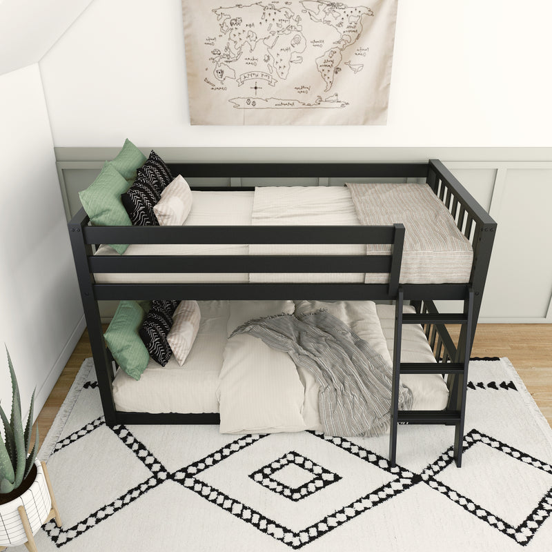 Modern black metal bunk bed with neutral bedding, decorative throw pillows, and stylish bedroom decor featuring a world map wall art, ideal for small spaces.
