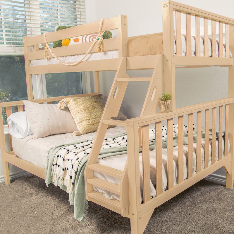 Modern wooden bunk bed with cozy bedding and stylish pillows in a bright room with large windows.