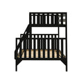 Black wooden loft bunk bed with ladder, vertical slatted guardrails and wooden slat mattress support — modern space‑saving kids bed