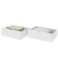 White under-bed storage drawers with folded beige blanket and quilted bedding, space-saving bedroom storage solution