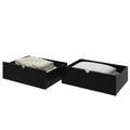 Black under-bed storage drawers with folded blankets and quilted pillow, space-saving bedroom storage solution