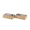 Two light-wood under-bed storage drawers filled with neatly folded linens and rolled clothing for bedroom organization