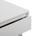 Close-up of a white modern handleless nightstand drawer showing minimalist bedside table design, matte finish and clean lines