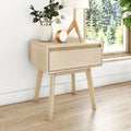 Minimalist Scandinavian light wood bedside table with single drawer and tapered legs, styled with lamp, white vase and gold clock by window
