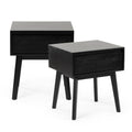Pair of black wooden mid-century modern nightstands with single drawers and tapered legs, bedside table set on white background