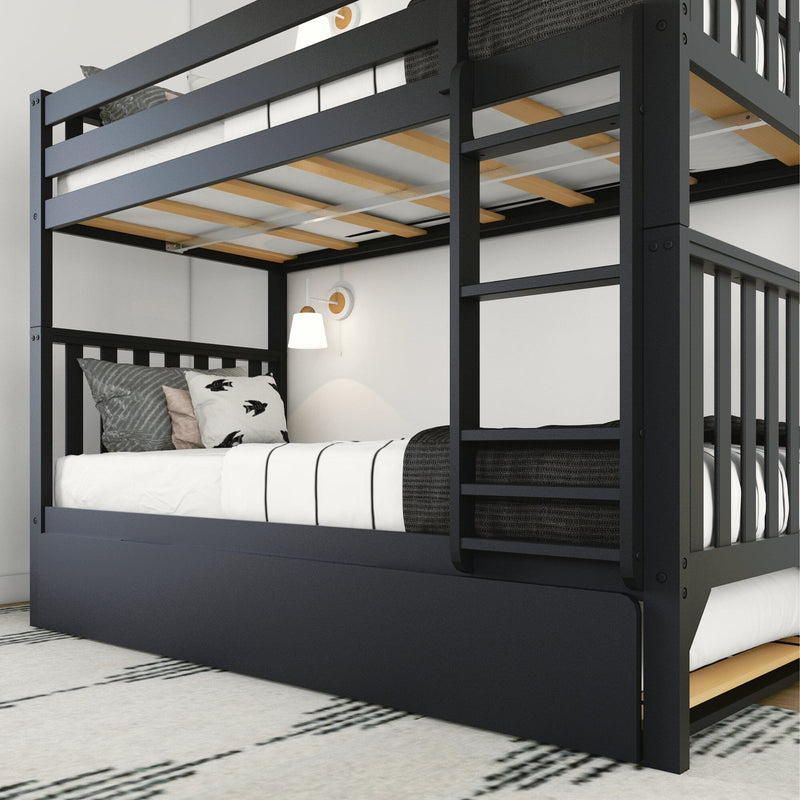 Modern black twin-over-full bunk bed with ladder and pull-out trundle, white striped bedding, decorative pillows and wall sconce in a minimalist kids' bedroom — space-saving bunk-bed design