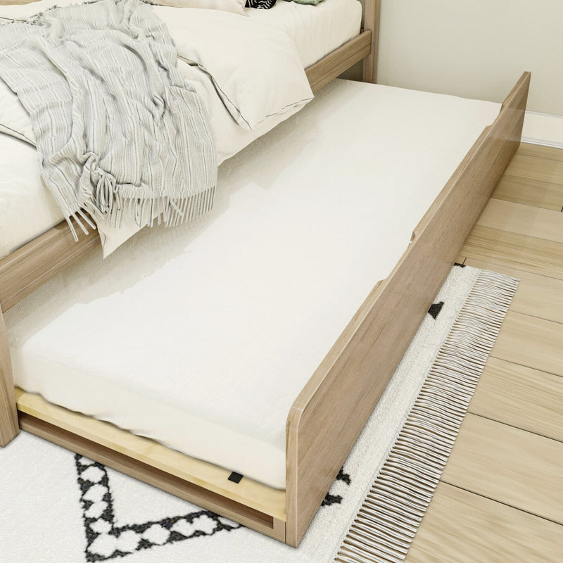 Wooden trundle bed with pull-out mattress and cozy bedding.