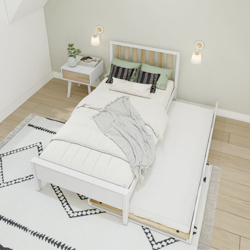 White trundle bed in a minimalist Scandinavian bedroom with neutral bedding, patterned black-and-white pillows, green accent cushions, white bedside nightstand, wall sconces and light wood floors