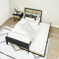 Modern minimalist bedroom interior with black metal bed frame and pull-out trundle, light wood slat headboard, neutral linens, patterned black-and-white rug, nightstand with plant, wall sconces and hardwood floor