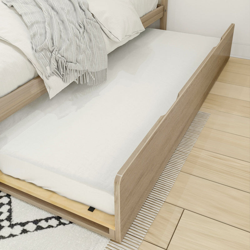 Natural wood trundle bed with bedding on wooden floor, ideal for space-saving bedroom furniture solutions.