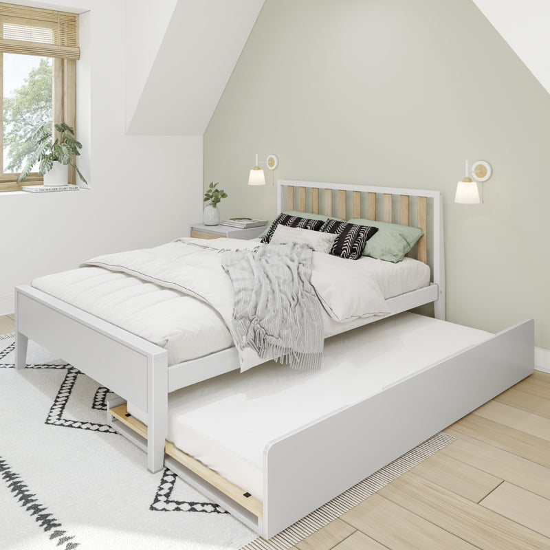 Scandinavian minimalist bedroom with white wooden bed and pull-out trundle, neutral bedding, patterned pillows, light green accent wall, modern wall sconces and window plant