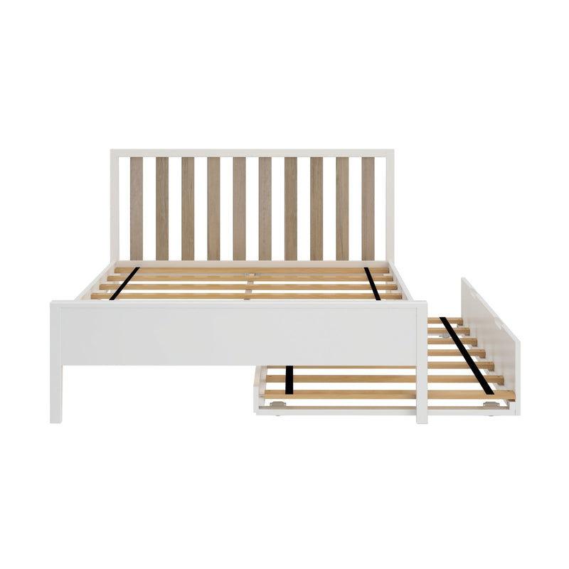 White wooden platform bed with vertical slatted headboard and pull-out underbed trundle, modern farmhouse design