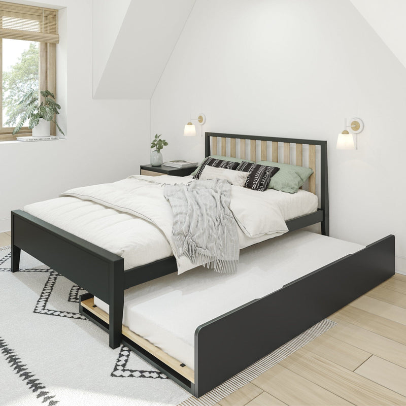 Modern bedroom with cozy bed featuring a pull-out trundle, white linens, geometric rug, and natural light from a window, ideal for small spaces.