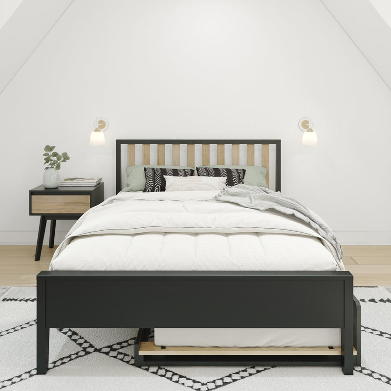 Modern minimalist bedroom with black-frame wood-slat bed, white bedding and patterned pillows, nightstand with books and vase, wall sconces and neutral decor