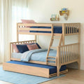 Space-saving solid natural wood bunk bed with pull-out trundle and ladder, light oak finish with navy and blush bedding in a minimalist kids' bedroom