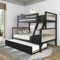 Modern black wood twin-over-full bunk bed with ladder and pull-out trundle in a bright minimalist kids’ bedroom with white bedding, patterned rug and potted plant