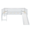 White loft bed with attached slide and ladder for kids' room.