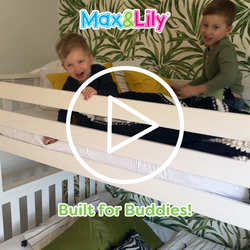 Two children playing on a Max & Lily white bunk bed with colorful bedding and jungle-themed wallpaper.