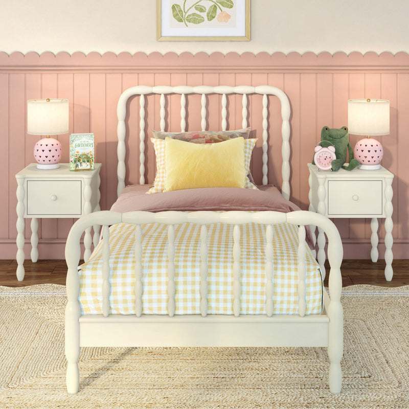Cozy pastel girls bedroom with white spindle twin bed, yellow gingham bedding, pink scalloped wainscoting, matching nightstands, lamps and plush frog