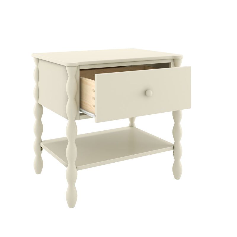 Cream wooden bedside nightstand with turned spindle legs, single open drawer and lower shelf for bedroom storage, farmhouse-style.