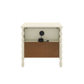 Cream wooden bedside table with turned spindle legs, open back panel and built-in cable management with coiled power cord