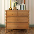 Wooden dresser with brass lamp, smiling fabric potted plant, stacked books and vintage tennis racket — rustic bedroom decor