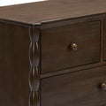Close-up of dark brown solid wood dresser corner with turned leg, round drawer knob and smooth wood grain finish