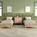 Sunlit green kids bedroom with twin wooden beds, striped bedding, wooden dresser, frog plush toy and framed ocean prints — cozy nursery decor