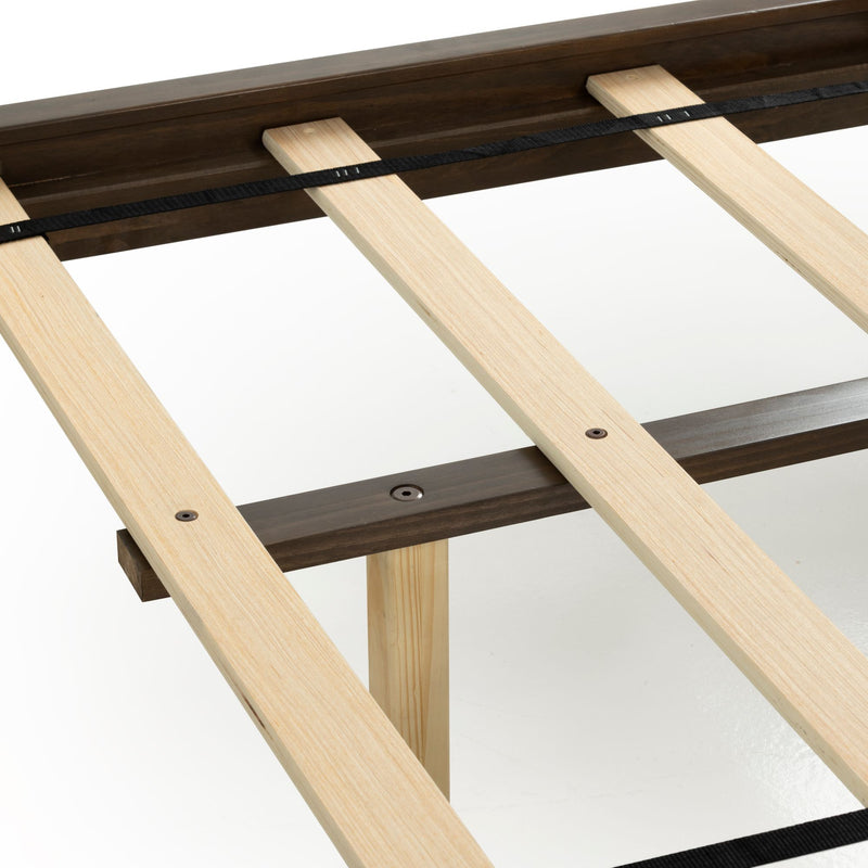 Close-up of platform bed frame wooden slats and dark wood side rails showing support system with black fabric strap