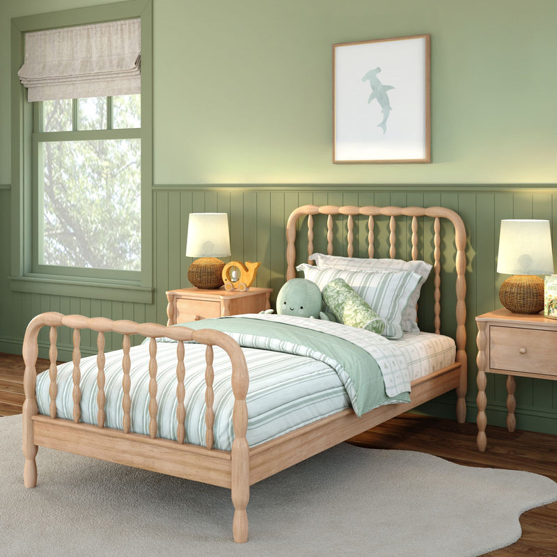 Cozy green children's bedroom with natural wood spindle bed, mint striped bedding, plush octopus toy, wicker bedside lamps, and framed wall art